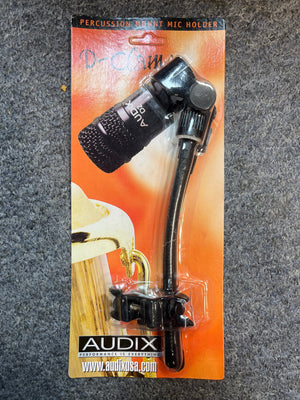 Audix D-Clamp Percussion Mount Mic Holder by Audix, in original packaging with small mic, mounting hardware, and D-Clamp microphone clamp, displayed on an orange background.