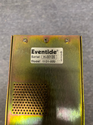Close-up of a metallic Eventide H8000 Multi-Channel Effects System (Preowned) shows its label, serial number H-00120, model 1131-000, along with four screws and a vent grid on this harmonizer and multi-effects processor.