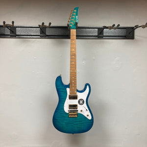 Jamstik Deluxe MIDI Blue Guitar w/Case on a wall hook, showcasing its electric design and industry-leading MIDI capabilities.