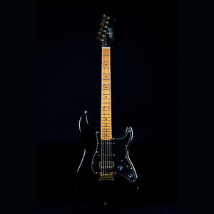 JET-400 black electric guitar with gold strings, featuring a sleek design, HSS pickups, and tremolo bridge for versatile play.