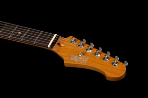 Close-up of the Jet JS-400 BKR H electric guitar headstock by Jet, showcasing its wooden finish with six tuning pegs, strings, and fretboard against a black background. Equipped with dual ceramic HH pickups, this guitar delivers versatile sound and modern playability for contemporary performance.