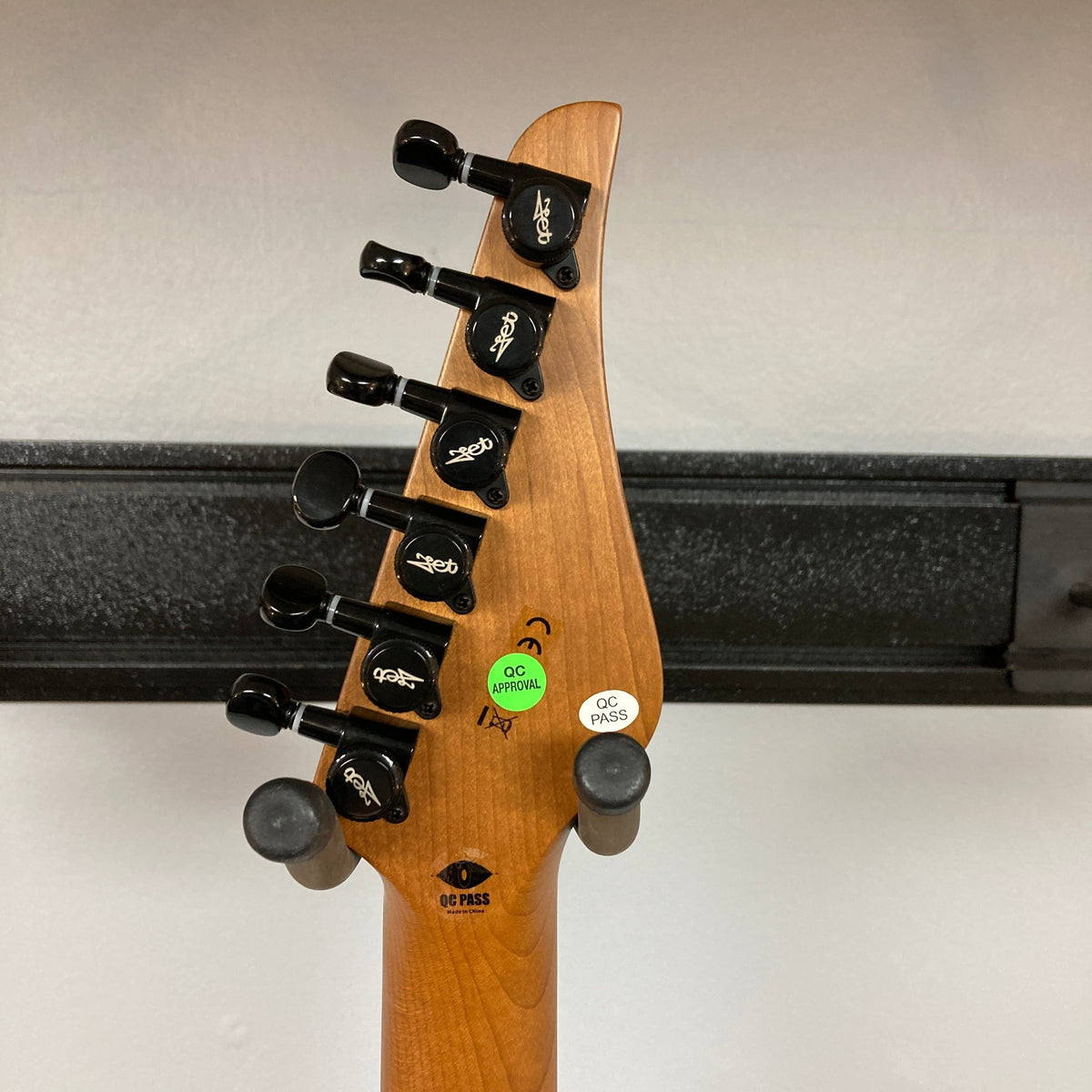 JET JS-450 Transparent Green guitar close-up, highlighting its sleek design, reversed headstock, and locking tuners. Perfect for style and performance-focused musicians.