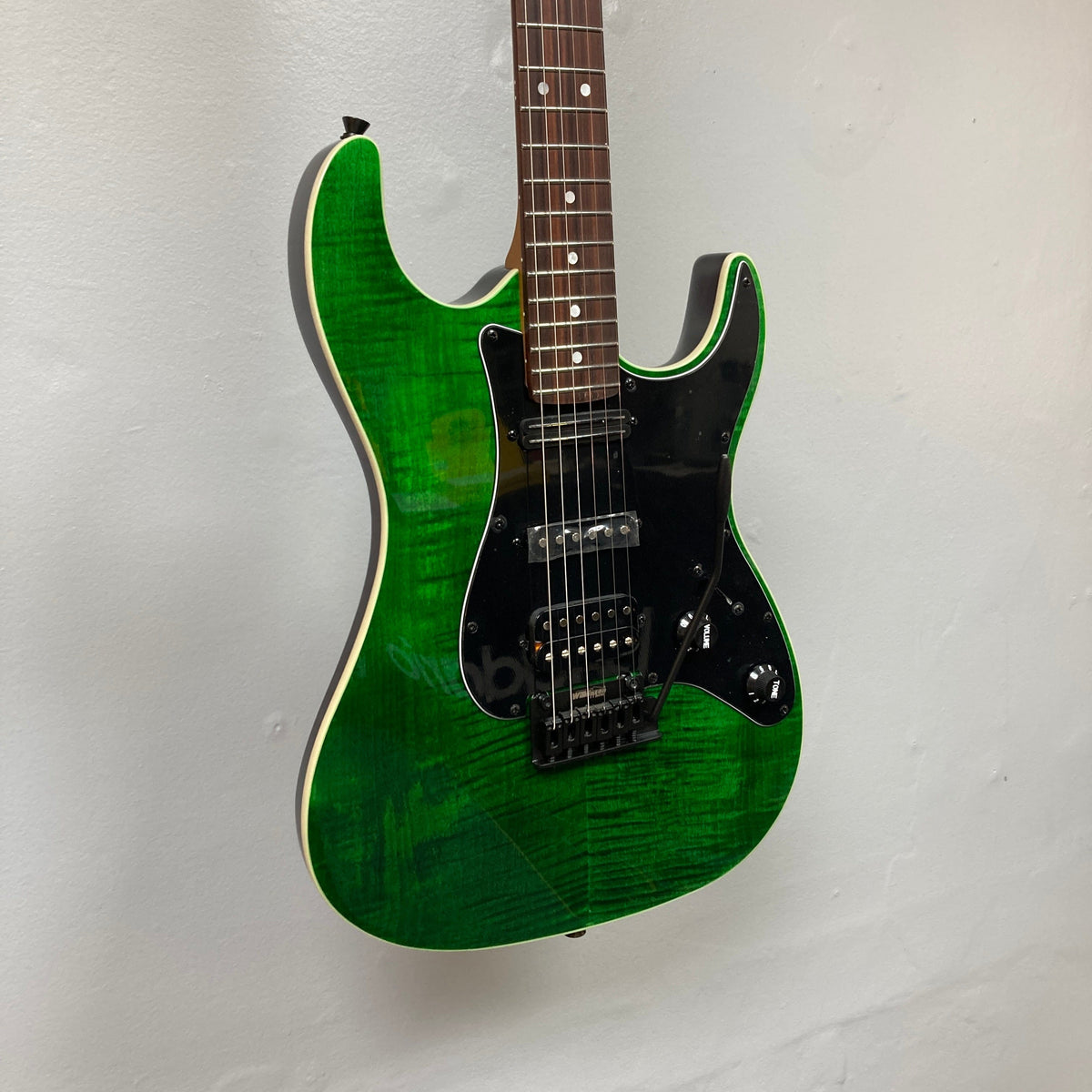 JET JS-450 Transparent Green electric guitar with HSS pickups, flamed maple top, and Wilkinson Tremolo, designed for modern playability and style.