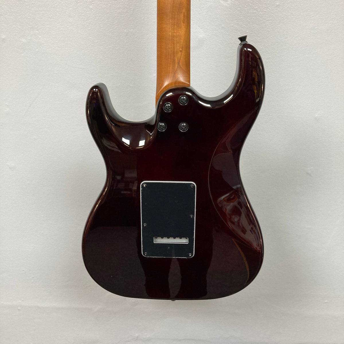 Close-up of the JET JS-450 Transparent Green guitar, featuring a flamed maple top and HSS pickup configuration, ideal for modern players seeking style and performance.