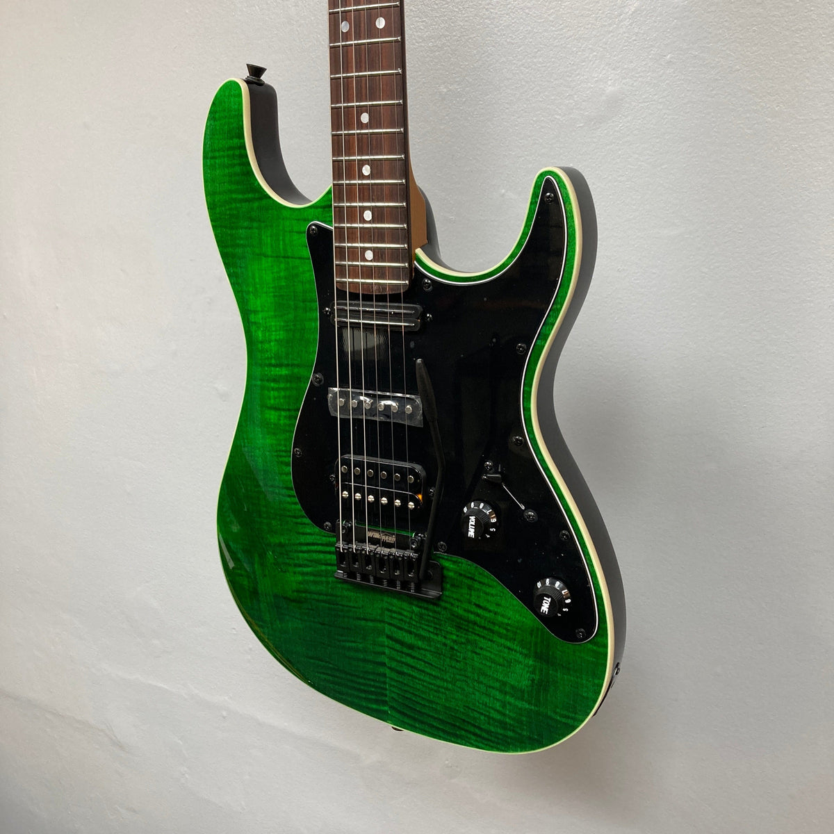 JET JS-450 Transparent Green electric guitar with a flamed maple top and reversed headstock, showcasing its sleek design and versatile features.