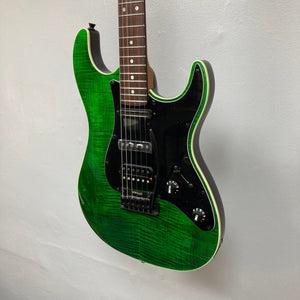 JET JS-450 Transparent Green electric guitar with a flamed maple top and reversed headstock, showcasing its sleek design and versatile features.