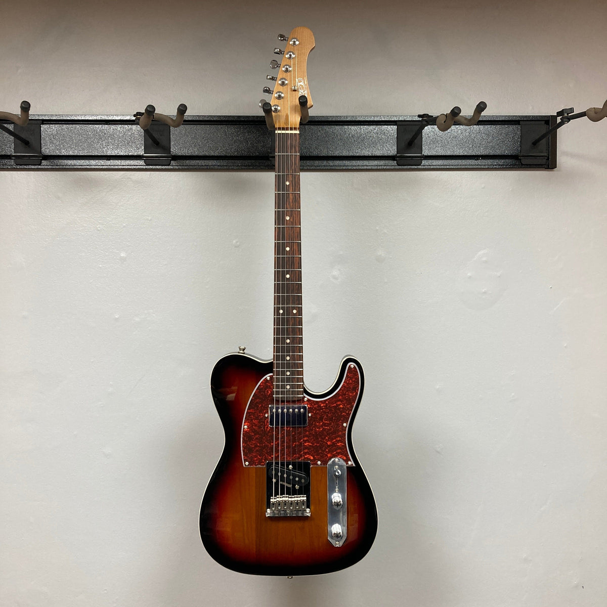 JET JT-350 guitar on a wall, showcasing its classic tone and modern design with SH Alnico pickups and a Canadian roasted maple neck.
