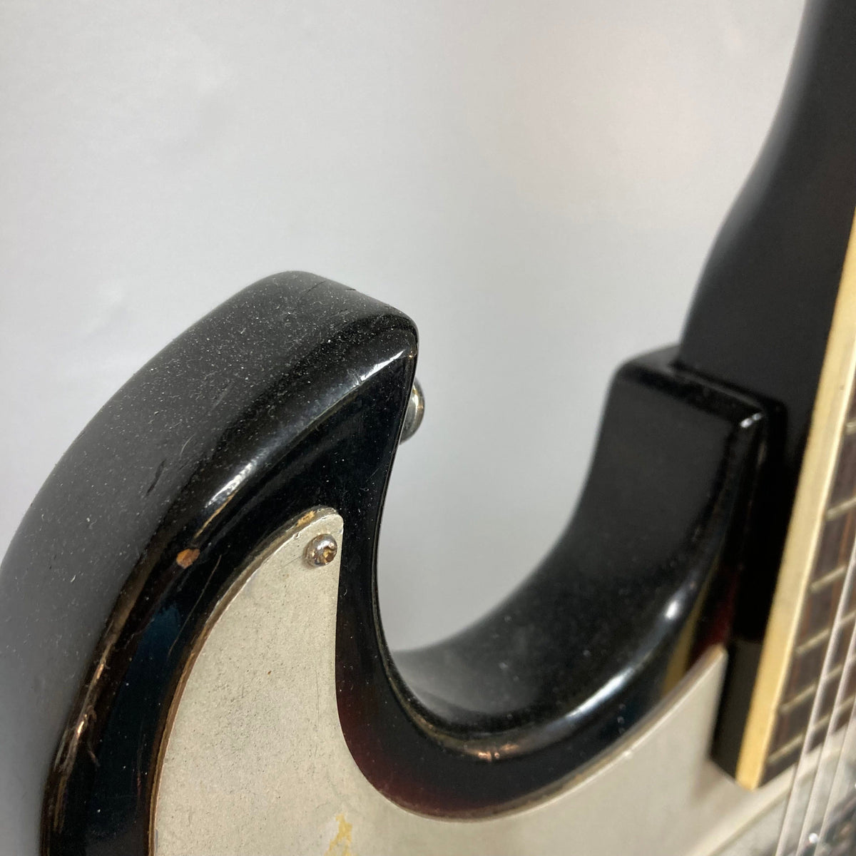 Close-up of the Kawai Vintage 1960s Kawai Teisco Japan Hound Dog Reburst guitar, showcasing its unique vintage design and craftsmanship.