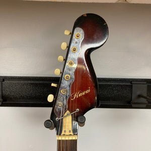 Kawai Vintage 1960s Kawai Teisco Japan Hound Dog Reburst guitar on a rack, showcasing close-up details of its strings and craftsmanship.