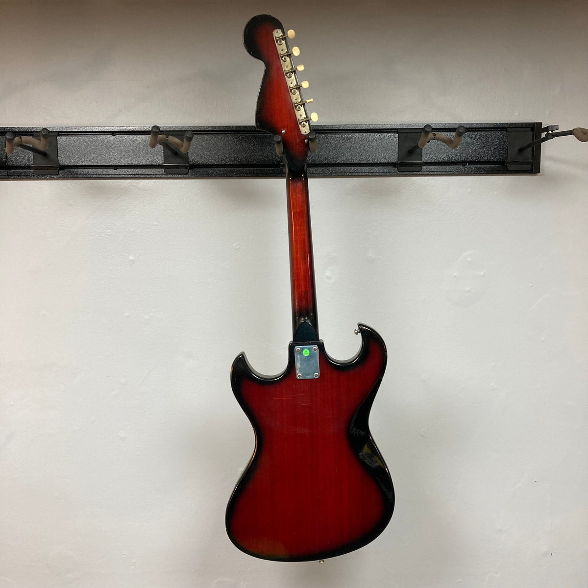 Kawai Vintage 1960s Kawai Teisco Japan Hound Dog Reburst electric guitar on a stand, showcasing its distinctive Hound Dog burst finish and vintage design.