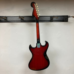 Kawai Vintage 1960s Kawai Teisco Japan Hound Dog Reburst electric guitar on a stand, showcasing its distinctive Hound Dog burst finish and vintage design.