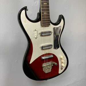 Kawai Vintage 1960s Kawai Teisco Japan Hound Dog Reburst guitar close-up, showcasing knobs, strings, and switch details against a wall.