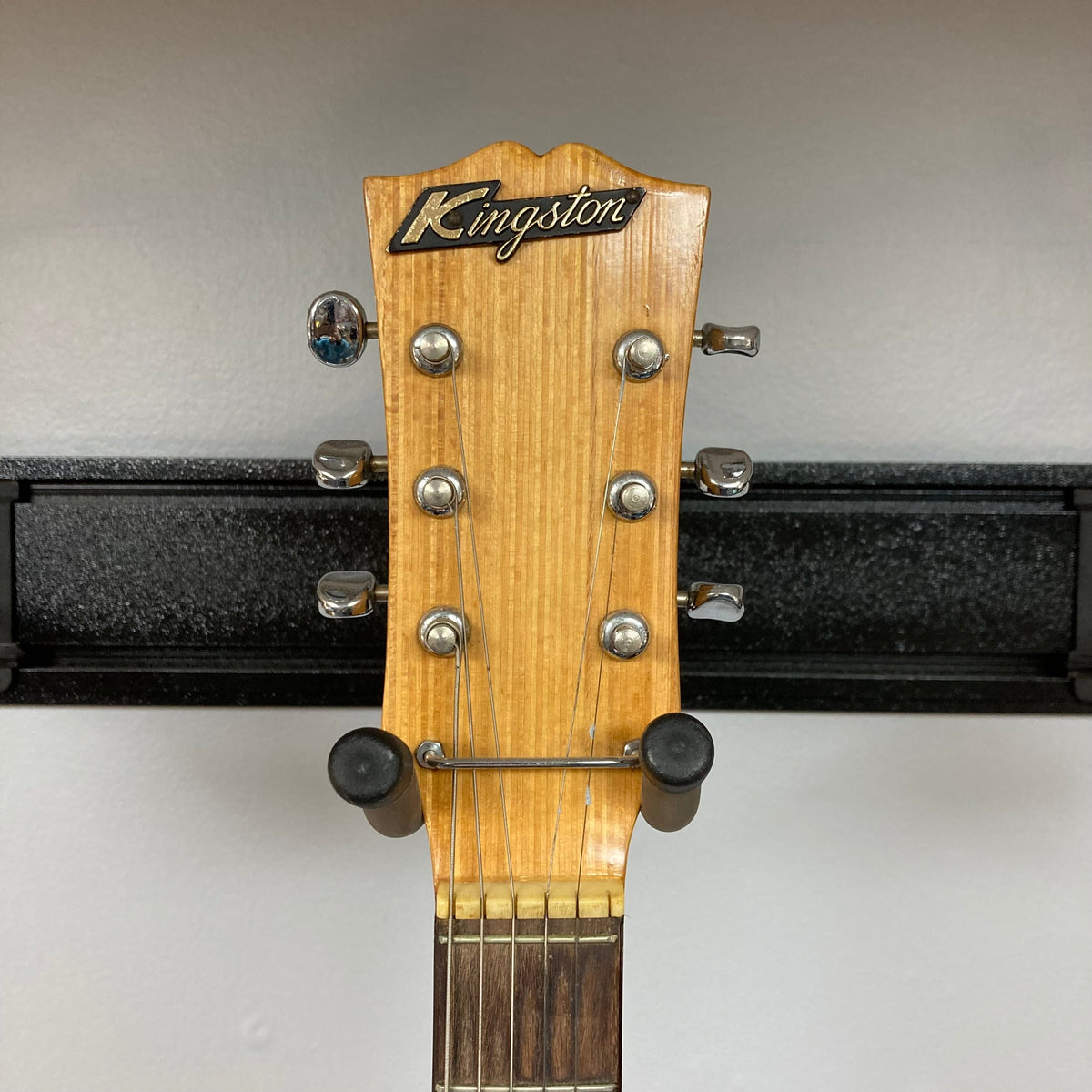 Kingston Semi-Hollowbody 1960's Vintage Burst guitar displayed on a wall, showcasing its semi-hollow design and vintage aesthetic.