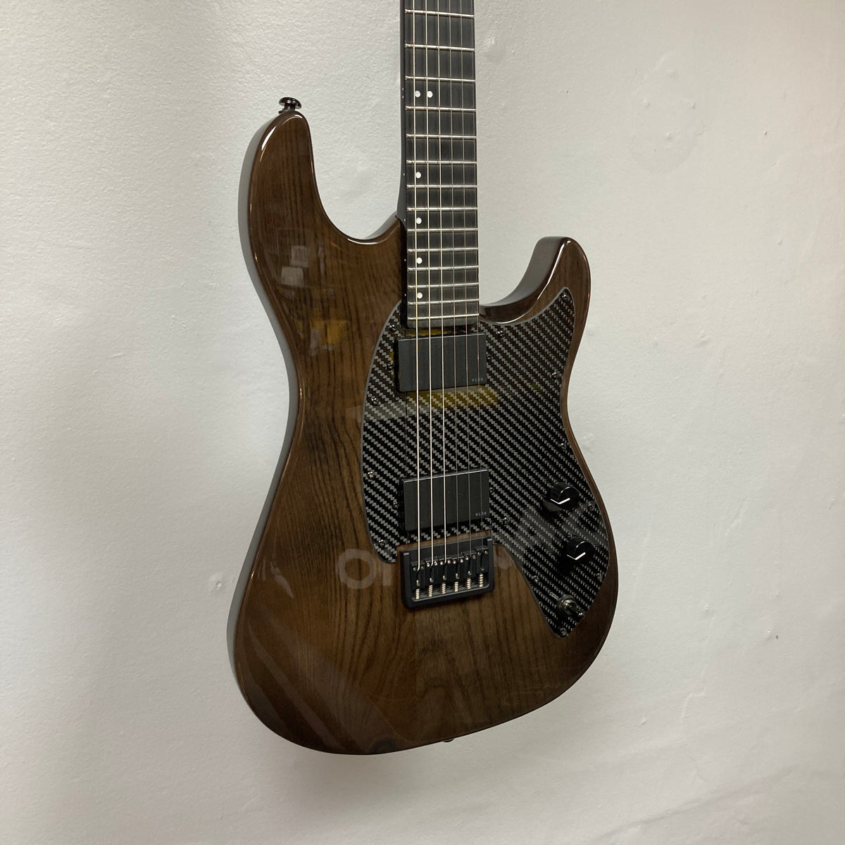 KLOS Apollo Pro Electric Guitar Dark Brown with carbon fiber neck and ash body, showcasing modern design and innovative craftsmanship against a white wall.