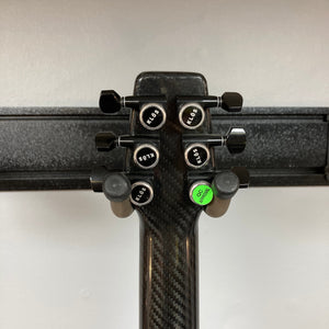 KLOS Apollo Pro Electric Guitar close-up, showing carbon fiber neck and aluminum strap pin buttons, highlighting its innovative design and craftsmanship.