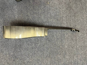 A side view of the Klos Grand Cutaway AE w/Fishman acoustic guitar lies on a gray carpeted floor, displaying its body, neck, and tuning pegs.