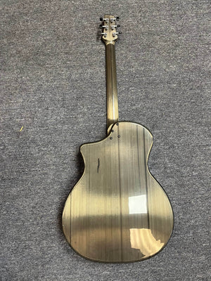 A Klos Grand Cutaway AE w/Fishman acoustic guitar with a glossy, striped back and cutaway body design lies face down on a gray carpeted floor.