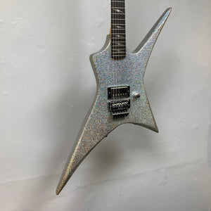 Kramer Lzzy Hale Voyager guitar with sleek design, black diamond holographic sparkle finish, and chrome hardware, hanging on a wall.