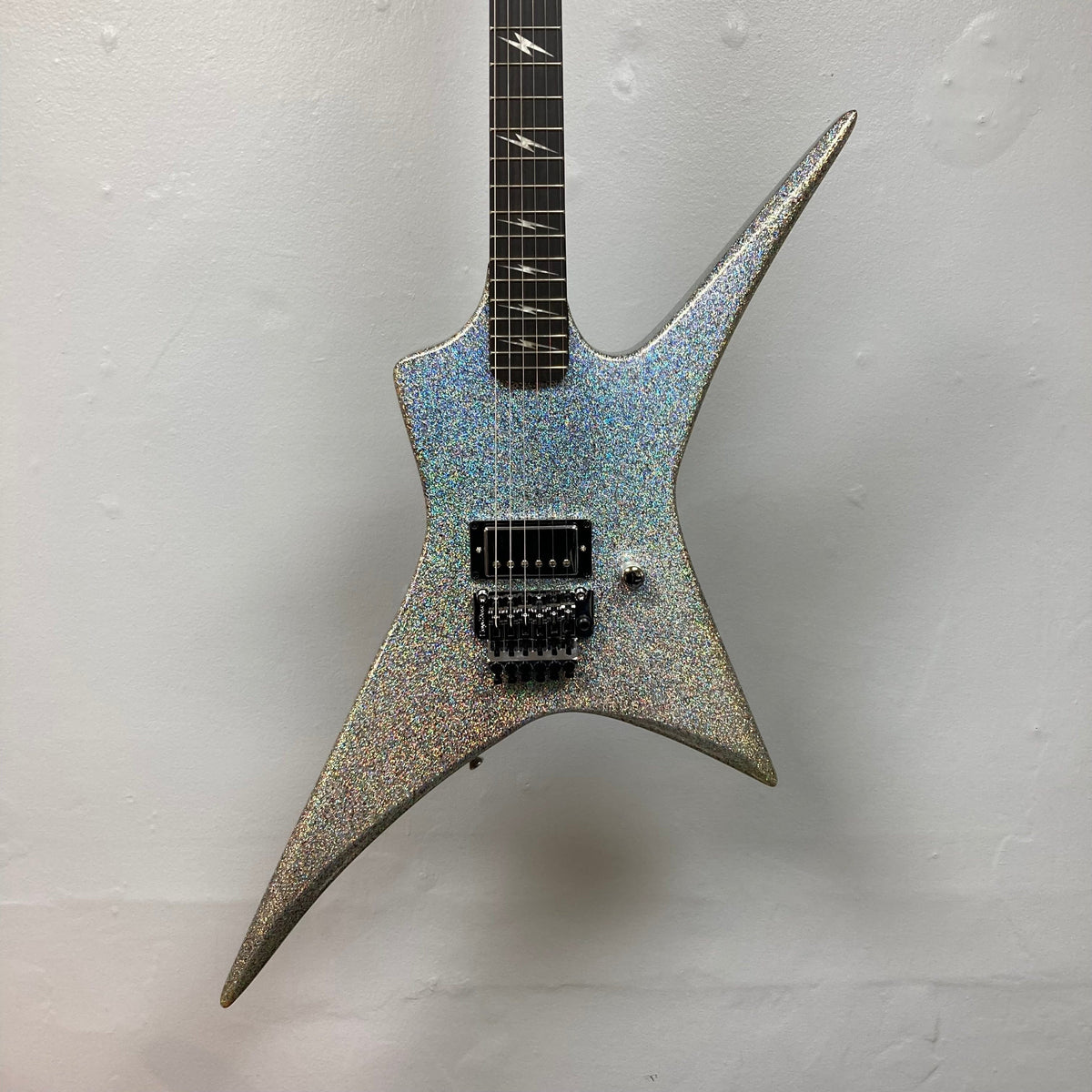 Kramer Lzzy Hale Voyager electric guitar on a wall, highlighting its sleek design and high-performance features.