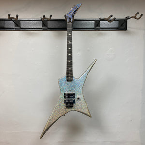 Kramer Lzzy Hale Voyager guitar on a wall hook, showcasing its bold design and high-performance features.