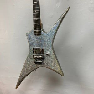 Kramer Lzzy Hale Voyager: sleek, silver guitar with black neck, close-up of strings and neck, ideal for rock enthusiasts.