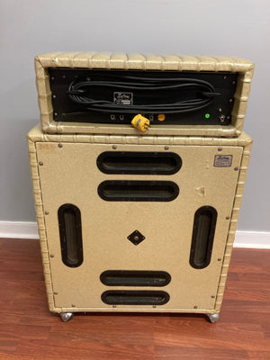 Kustom K250-4 Amp and Speaker Cabinet Gold Sparkle Tuck and Roll on a wooden floor, showcasing its vintage design and powerful sound features.