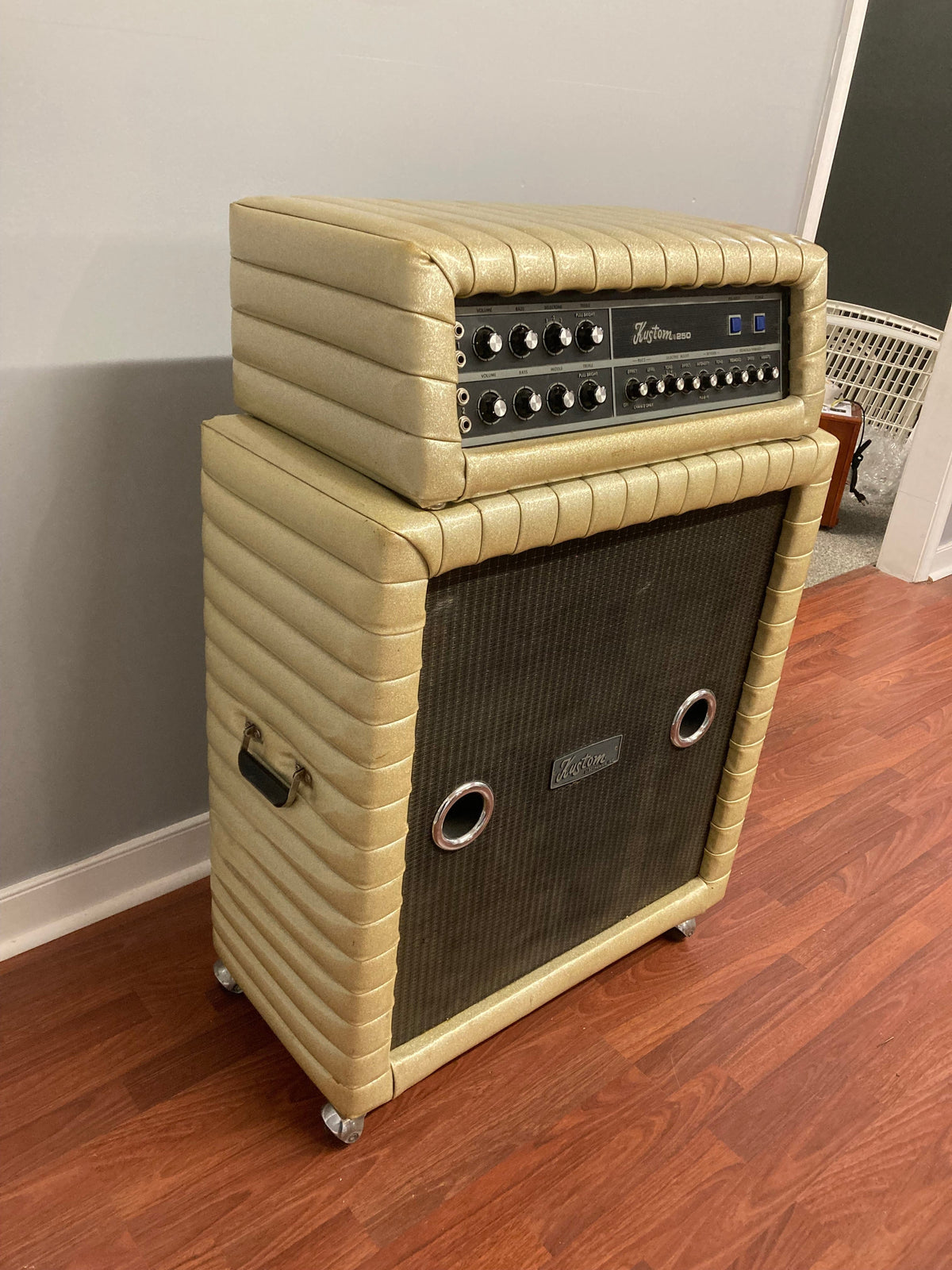 Kustom K250-4 Amp and Speaker Cabinet with gold sparkle tuck and roll design, shown up close highlighting its vintage aesthetic and detailed craftsmanship.