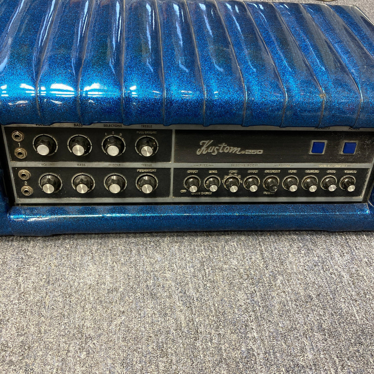 Kustom K250 Amp Head with blue sparkle design, featuring buttons and knobs for versatile sound.