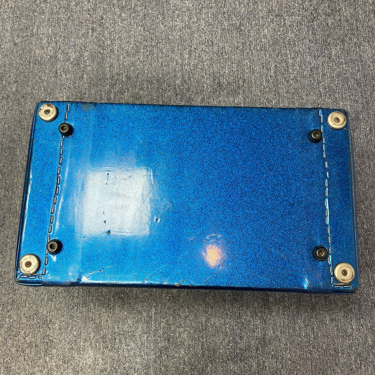 Kustom K250 Amp Head Blue Sparkle Tuck and Roll, featuring a blue body with metal rivets and a keyhole, reflecting retro style and solid-state power.