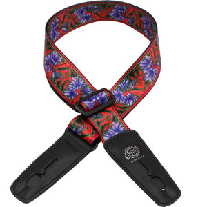 Lock-It Straps artist series by Bob Masse, featuring a colorful floral design with black leather ends and a unique locking mechanism for secure guitar performance.
