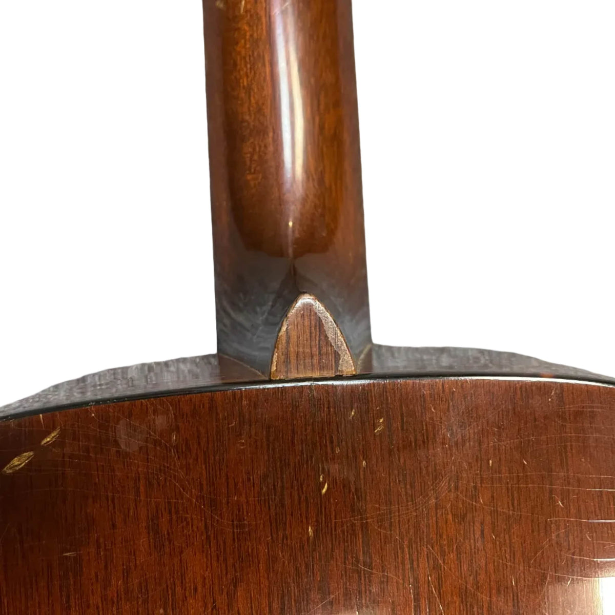 Close-up of the neck joint on a Martin 00-18G Classical Guitar (c. 1961–1962), highlighting the heel and a portion of the scratched, worn body.