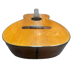 Photographed from the body end, this vintage Martin 00-18G Classical Guitar (c. 1961–1962) displays its nylon strings, sound hole, and wooden finish against a white background.