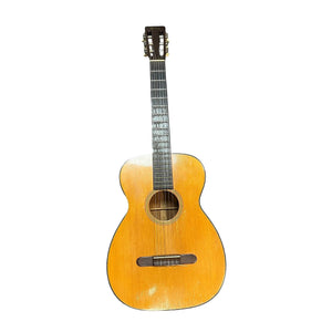 A Martin 00-18G Classical Guitar, c. 1961–1962, by Martin features a natural wood finish, dark fretboard, and visible wear marks on the body, photographed against a white background.