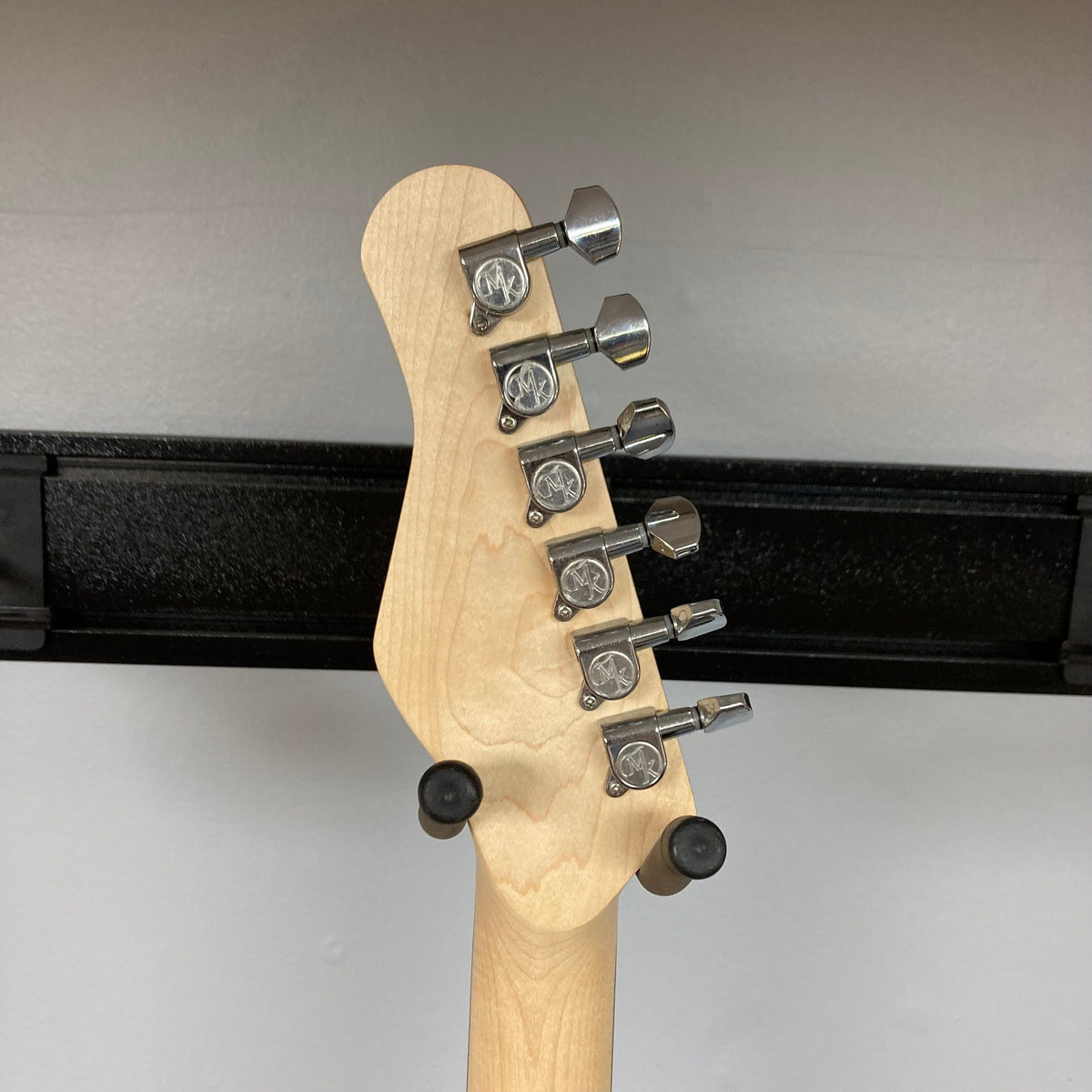 Michael Kelly 53 Tele Gloss Gray Prototype Demo featuring a close-up of its neck with silver tuning keys.