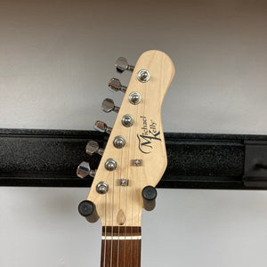 Michael Kelly 58 Tele Thinline Flame Maple guitar head with silver tuning pegs, showcasing the logo and craftsmanship.