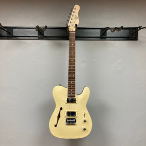 Michael Kelly 58 Tele Thinline Flame Maple Prototype Demo guitar mounted on a wall, showcasing its semi-hollow body and sleek design.