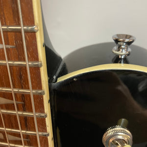 Close-up of a Michael Kelly Patriot Decree Lefty Black Blem guitar showcasing its mahogany body, set neck, and chrome hardware.