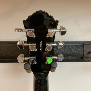 Close-up of the Michael Kelly Patriot Decree Lefty Black Blem guitar, highlighting details like mahogany body, PAF pickups, and chrome hardware.