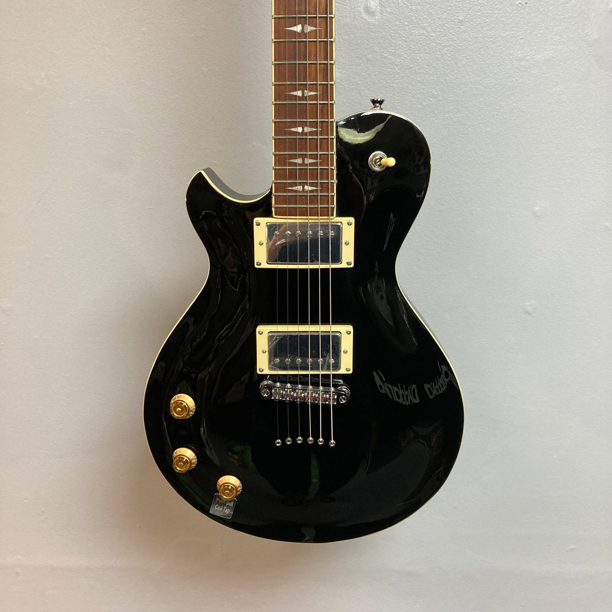 Michael Kelly Patriot Decree Lefty Black Blem electric guitar with gold knobs, PAF pickups, and 22 frets, displayed on a white background.
