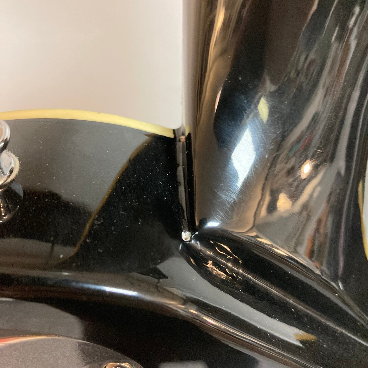 Close-up of the Michael Kelly Patriot Decree Lefty Black Blem guitar body, showcasing its glossy finish and craftsmanship.
