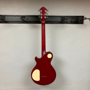 Michael Kelly Patriot Decree Open Pore Slim Body Cherry Red guitar with silver knobs on a stand, showcasing its sleek design and premium hardware.