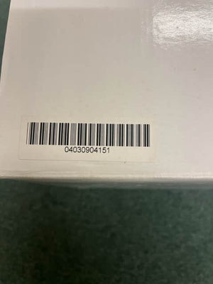 A white box with a barcode sticker showing 04030904151, possibly containing a Monster Power AVS 2000 PRO Professional Reference Automatic Voltage Stabilizer by Monster Power, rests on a green surface.