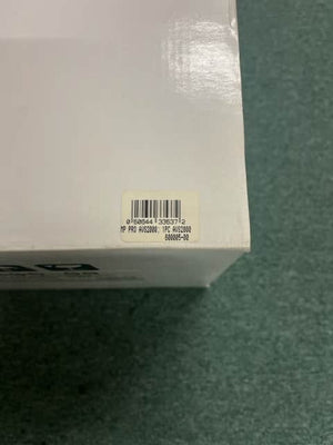 A close-up of a white box with a barcode sticker labeled “HP PRO AWS2000, PRC AWS2000, 600065-00,” possibly for the Monster Power AVS 2000 PRO Professional Reference Automatic Voltage Stabilizer by Monster Power, on a green surface.
