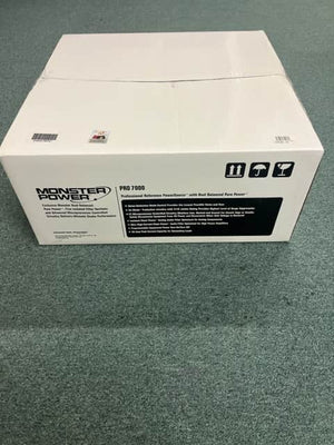 A sealed white box labeled "Monster Power PRO 7000 Professional Reference PowerSource" by Monster Power sits on a green carpeted floor, with handling symbols visible on the side.