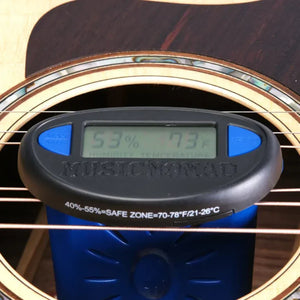 The Music Nomad The Humitar ONE – Acoustic Guitar Humidifier & Hygrometer by Music Nomad sits between the strings and soundhole, displaying 53% humidity and 73°F while indicating the safe zone for your acoustic guitar.