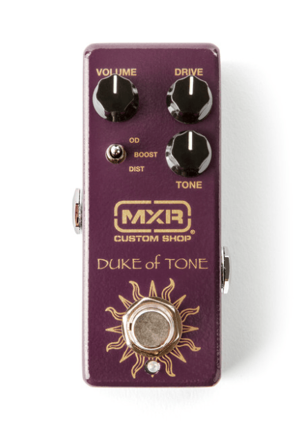 The MXR CSP039 Duke of Tone Overdrive Pedal, designed with Analog Man, features a purple case, three knobs (Volume, Drive, Tone), a toggle switch, and a footswitch on the lower section. The MXR CSP039 Duke of Tone Overdrive Pedal, designed with Analog Man, features a purple case, three knobs (Volume, Drive, Tone), a toggle switch, and a footswitch on the lower section.
