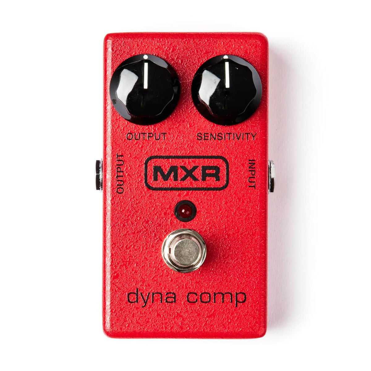 The MXR® Dyna Comp® Compressor from MXR features a red casing, two black knobs for Output and Sensitivity, input/output jacks, and a silver footswitch—a classic guitar effects pedal.