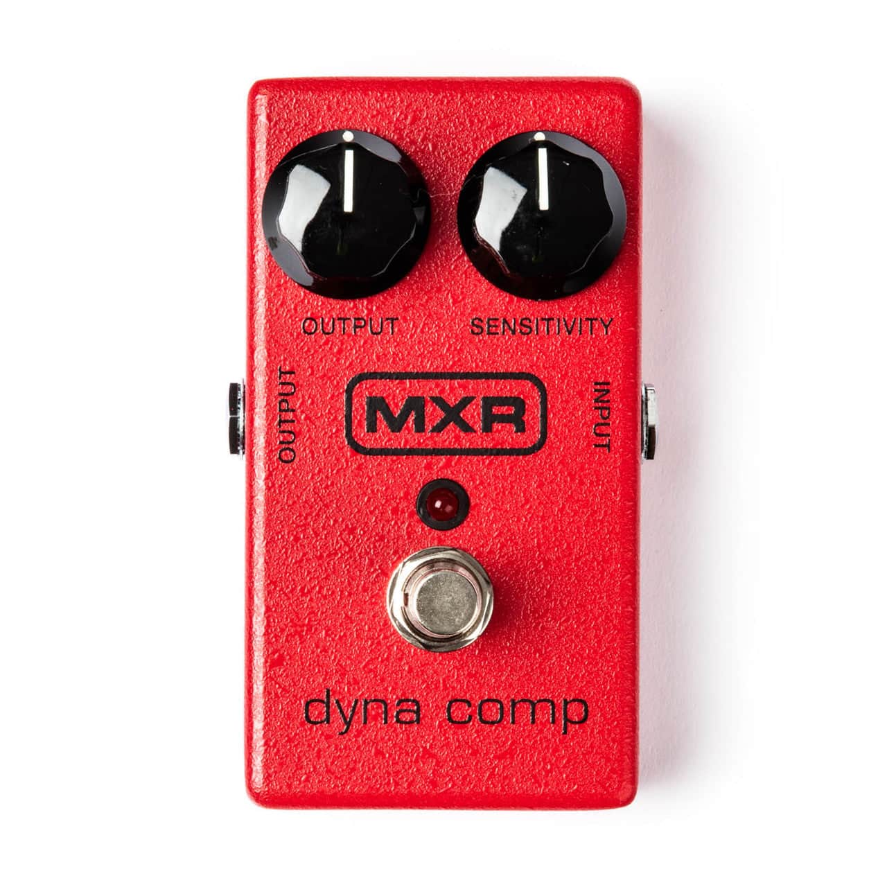 The MXR® Dyna Comp® Compressor from MXR features a red casing, two black knobs for Output and Sensitivity, input/output jacks, and a silver footswitch—a classic guitar effects pedal. The MXR® Dyna Comp® Compressor from MXR features a red casing, two black knobs for Output and Sensitivity, input/output jacks, and a silver footswitch—a classic guitar effects pedal.
