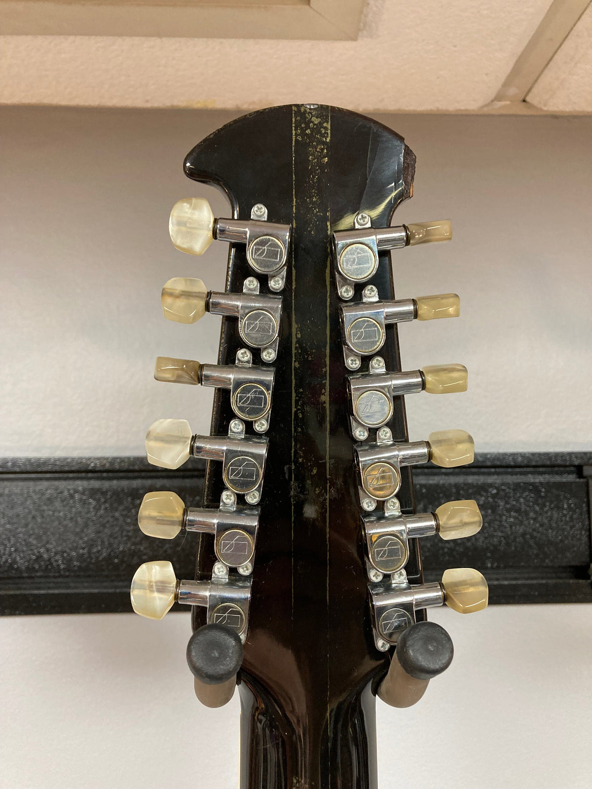 Close-up of an Ovation Deacon 12-String Electric Guitar, showcasing its solid body and 12-string configuration.
