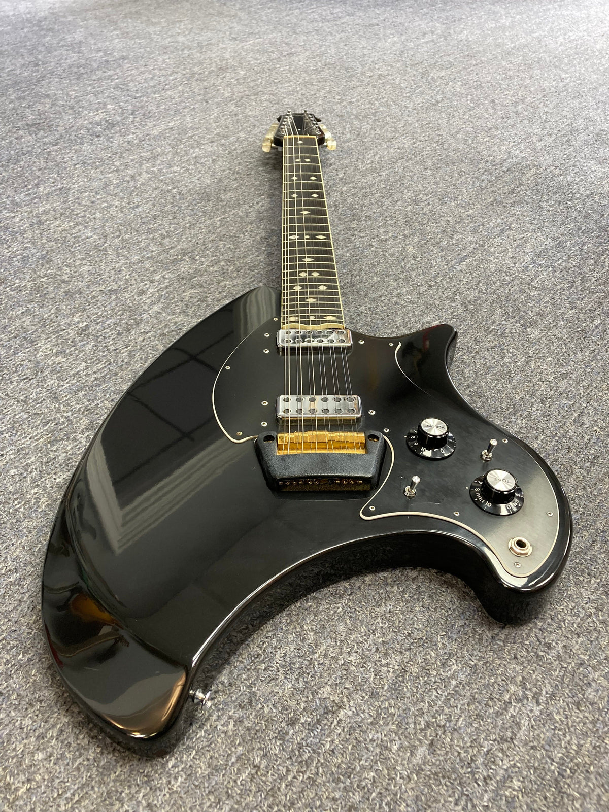 Ovation Deacon 12-String Electric Guitar Black, vintage model with solid body, visible volume knob, and minor wear on headstock and pickguard.